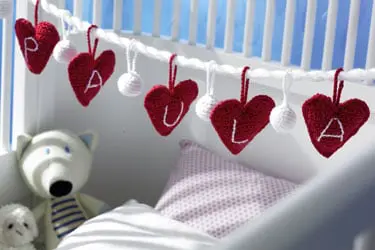 Babybett mit roten Herzen verziert