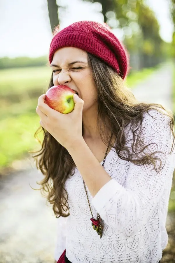 Frau beißt von Apfel