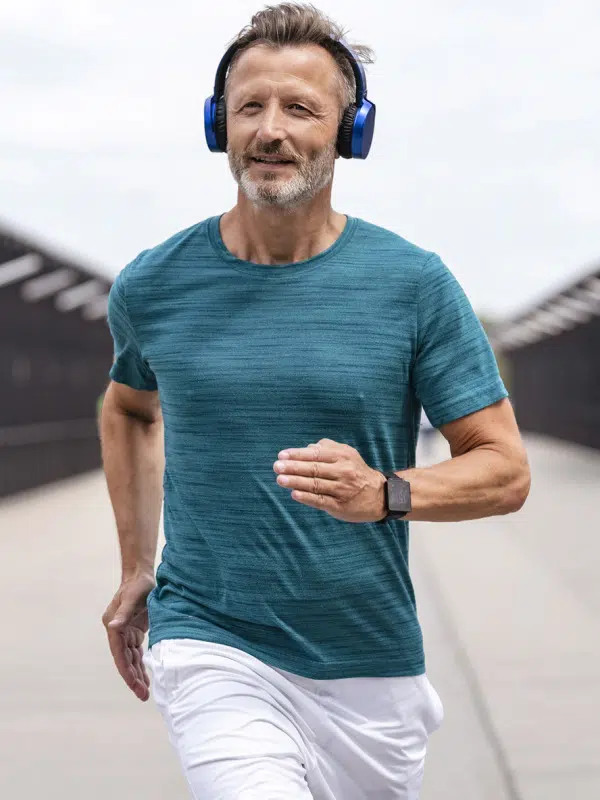 Sporty man wearing headphones and jogging